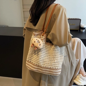 Retro hollow woven bucket bag in beige and brown contrast with leather straps