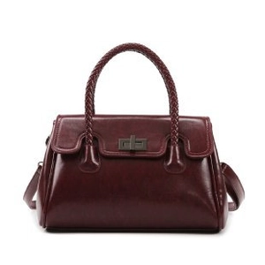 Deep red patent leather satchel with woven handle and secure metallic turn-lock closure