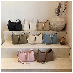Collection of textured half-moon armpit bags in eight diverse colors with silver chain