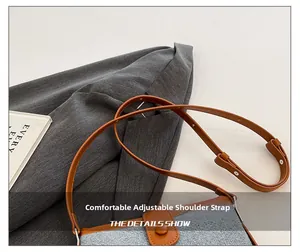 Detail of adjustable brown leather shoulder strap with metallic buckle on crossbody bag