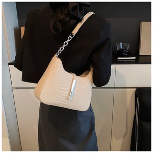 Détail du sac à bandoulière tissé crème avec boucle en métal argenté et chaîne