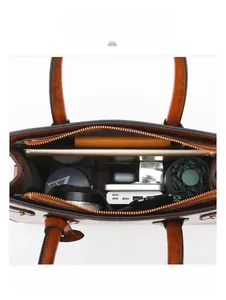 Macro view showing the large capacity interior and pockets of the brown retro tote bag