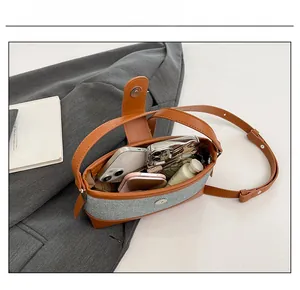 Top view of compact crossbody bag interior showing space for phones and skin care