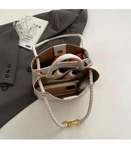 Interior view of crocodile-patterned tote bag with multiple compartments and weaving handle