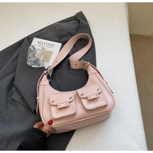 Detailed view of pink hobo underarm bag with silver hardware on elegant background