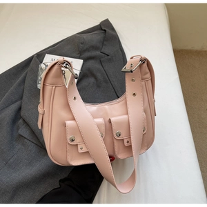 Detail of pink hobo bag featuring silver studs and adjustable wide shoulder strap