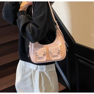 Close-up of pink PU leather Y2K hobo bag with silver rivets and dual front flap pockets