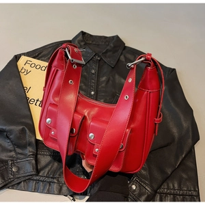 Macro shot of bright red faux leather bag with silver rivets and dual front flap pockets