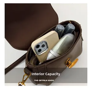 Top view of small vintage brown crossbody bag internal capacity with metal clasp