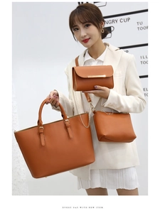 Three-piece camel leather tote set with crossbody and chain bags on a white suit model