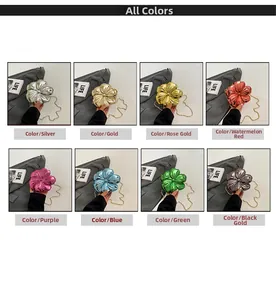 Multiple colors of mini flower crossbody bags with metal chains and metallic finishes