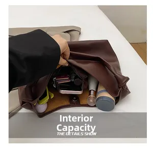 Detail view of large brown tote bag interior with multiple compartments and spacious storage