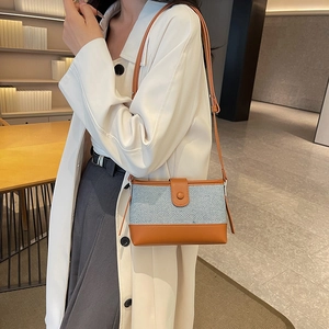 Blue fabric and brown leather patchwork shoulder bag with minimalist rectangular design