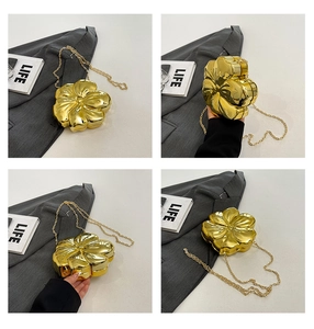 Detail view of the metallic gold flower evening bag with a delicate chain strap