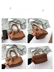 Viste dettagliate di una borsa a secchiello marrone con smartphone per riferimento taglia