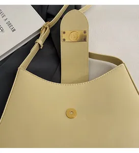 Close-up of polished gold magnetic clasp and premium leather texture on shoulder bag