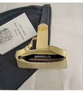 Top view of spacious interior in light yellow leather bag with golden hardware