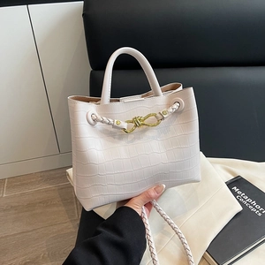 White crocodile pattern tote bag with gold twist lock and woven shoulder strap