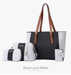 Detalle del juego de 4 bolsos de cuero Saffiano en blanco y negro con herrajes dorados