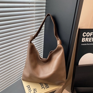 Brown litchi grain leather hobo bag with a knotted strap for casual office commuting