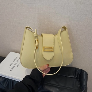 Cream crescent shoulder bag with golden lock and minimalist underarm strap design