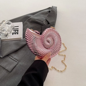 Pink shell-shaped acrylic shoulder bag with gold chain and nautilus spiral design
