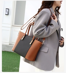 Détails du sac cabas en cuir marron foncé avec finitions métalliques dorées