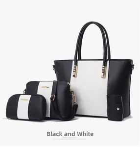 Détail d'un ensemble de 4 sacs cabas pour femmes en noir et blanc avec accents dorés