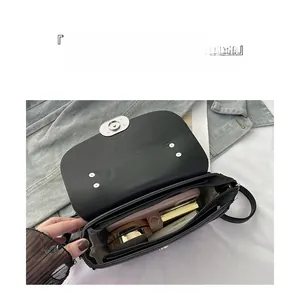 Crossbody bag interior detail showing large capacity compartments for phone and cosmetics