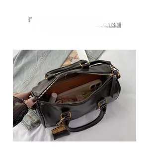 Internal view of brown Boston bag showing large capacity and multi-layer organizer pockets