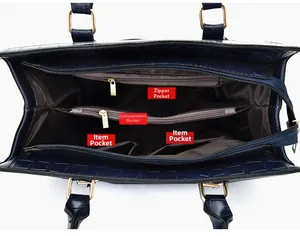Interior view of navy embossed handbag showing multiple compartments and golden zippers