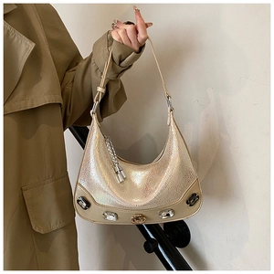 Detail of hobo crescent bag with snakeskin texture and crystal embellishments