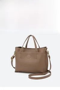 Detail of dark brown pebbled leather tote bag with gold hardware and strap hooks