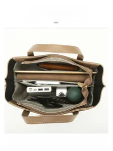Top view of large khaki tote bag interior showing multi-compartment storage for iPad and daily items
