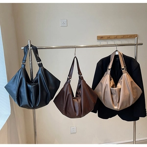 Close-up of litchi grain tote bags in black, brown and khaki with diamond fold design