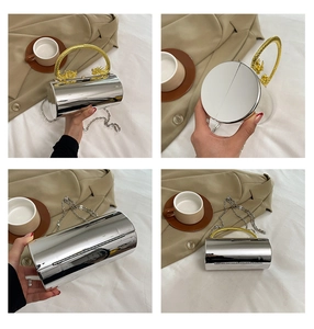Macro detail of cylindrical mirror silver evening bag with golden dragon handle