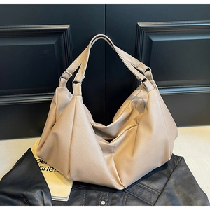 Detail of light brown lychee grain tote bag showing soft texture and wide handle