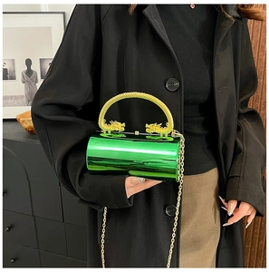 Detail of green mirror cylinder clutch featuring intricate gold double dragon handles and chain