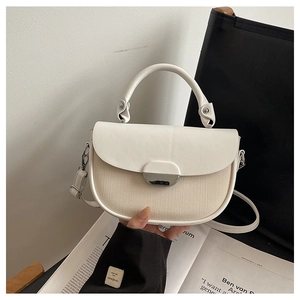Fashionable half-round patchwork handbag with white leather and beige canvas details