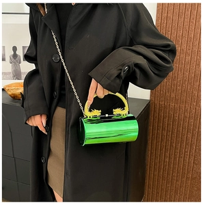 Detail of green acrylic cylinder bag with golden double dragon handle and chain strap