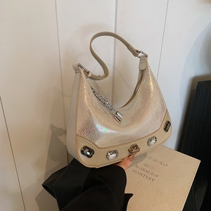 Elegant champagne snakeskin crescent bag with crystal studs and minimalist shoulder strap