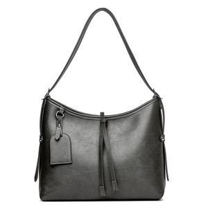 Classic hobo shoulder bag in retro black PU leather with decorative tassel details