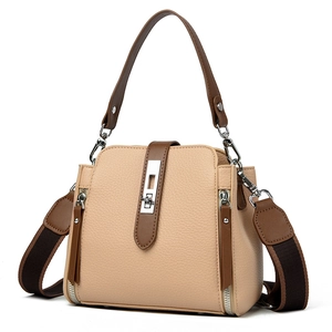 Minimalist beige bucket bag with brown straps and textured litchi pattern leather finish