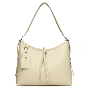 Creamy white hobo shoulder bag with minimalist leather drawstring knots in a sleek crescent shape