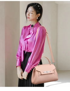 Detailed side view of apricot lychee pattern leather handbag with metal buckle closure