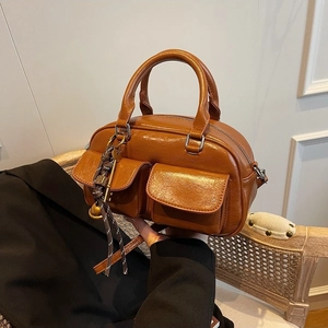 Vintage brown large capacity satchel bag with dual front pockets and key pendant