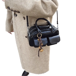 Retro black glossy leather Boston handbag with dual front pockets and shoulder strap