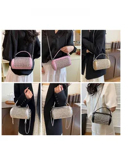 Detail shot of cylindrical crossbody bag with metallic studs in pink, gold and silver
