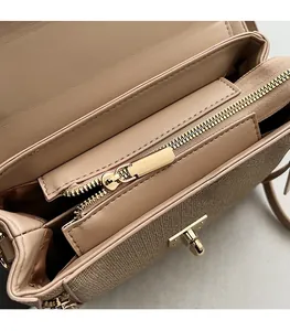Interior view showing the organized compartments and zipper pocket of the beige bag
