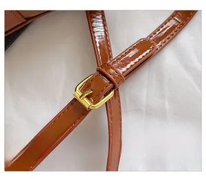 Macro shot of brown stone pattern leather strap with adjustable golden metal buckle